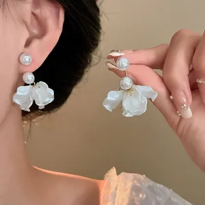 Detailed view of elegant white pearl earrings with translucent flower petal tassels