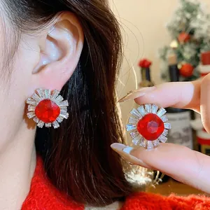 Elegant vintage royal style stud earrings with red crystal and zircon sunburst design.