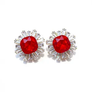 Vintage sunburst stud earrings with large red cushion-cut zircon and baguette halo stones