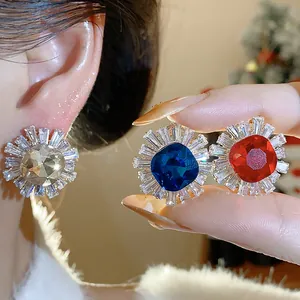 Macro view showing the intricate detail of luxury zircon sunburst stud earrings in three colors