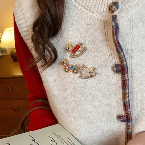 Elegant horse-shaped brooches with rhinestones and colorful enamel on a cardigan