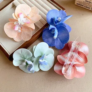 Elegant fabric orchid hair clips with pearls for a gentle and graceful seaside vacation look