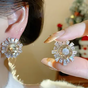 Close-up of sunburst zircon stud earrings with champagne center stone