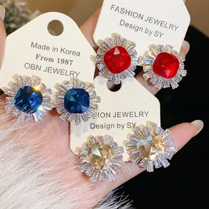 Close-up of vintage geometric stud earrings with sparkling zircon and palace style design