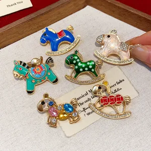 Detail showing rhinestone and enamel horse brooches with intricate craftsmanship
