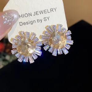 Close-up detail of vintage champagne sunburst earrings featuring clear baguette zircon stones