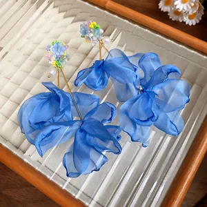 Exquisite detail of large blue chiffon flower tassel earrings with white pearls
