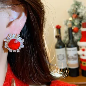 Detailed close-up of vintage palace style zircon stud earring with a radiant red center stone