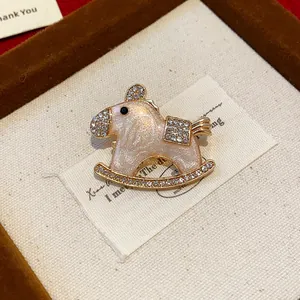 Macro view of an elegant enamel rocking horse brooch adorned with sparkling crystals
