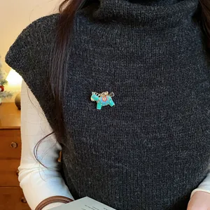 Detail shot of a colorful enamel pony brooch pinned on a dark knitted turtleneck vest.