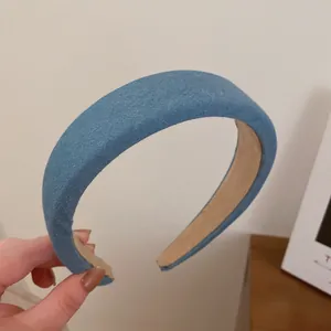 Detailansicht eines gepolsterten Haarreifs aus blauem Denim mit Fokus auf Textur