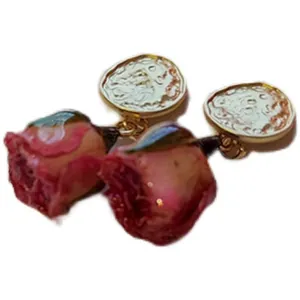 Elegant handmade forest style earrings featuring preserved real red dried rose buds
