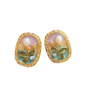 Elegant tulip flower stud earrings with enamel, pearls, and rhinestones on white background
