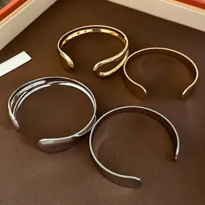 Vintage minimalist metal open bangles with teardrop and polished designs for women.