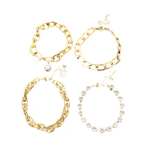Elegant set of four gold multi-layer chain bracelets with pearl and sparkling rhinestone details