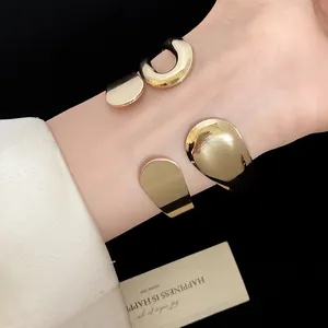 Detail view of stylish vintage gold waterdrop open cuff bracelets