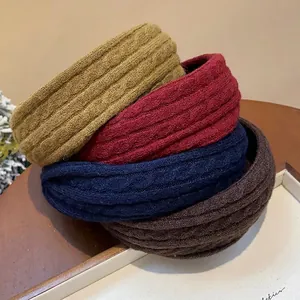 Knitted fabric headbands in autumn colors for a high skull top hairstyle look.