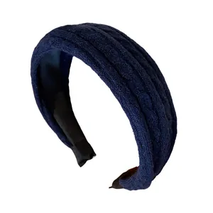 Navy blue cable knit headband with high top design for autumn winter fashion.