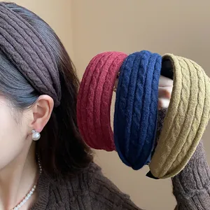 Four colors of wide cable-knit headbands for women, winter fashion hair accessories.