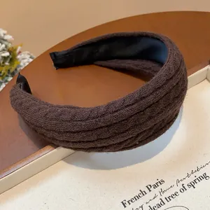 Close-up of brown knitted fabric headband with thick high cranial top design