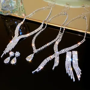 Detailed view of sparkling V-shaped rhinestone tassel necklace and teardrop earrings