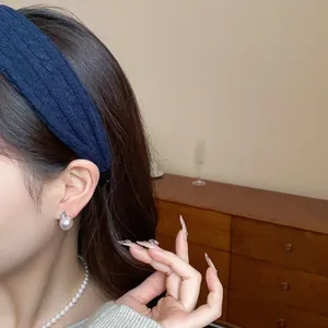 Close-up of a blue textured fabric headband on a model for a high skull top effect