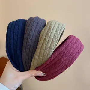 Close-up view of four cable knit padded headbands in navy, grey, khaki, and maroon