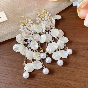 Elegant pearl earrings with white resin petal tassels and gold-toned silver needles