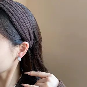 Close-up of a stylish brown knit fabric headband for trendy autumn and winter outfits