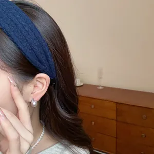 Close-up of navy blue fabric headband with pleated texture design