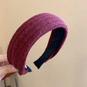 Detailed view of the burgundy knit fabric texture on a padded winter fashion headband
