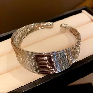 Detailed view of a silver multi-layered metal wire choker necklace inside a jewelry box