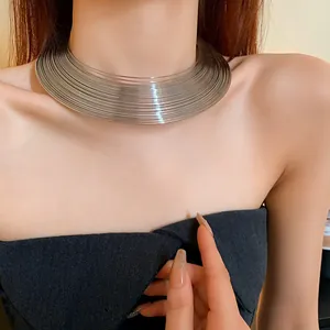 Detailed view of a silver multi-layered metallic choker necklace on a fashion model