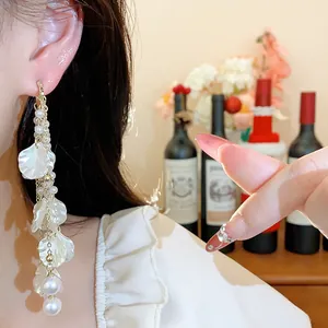 Elegant long tassel earrings featuring white petals and pearls for a light luxury look