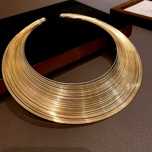 Close-up of a multi-layered gold metallic choker necklace with a sleek minimalist design