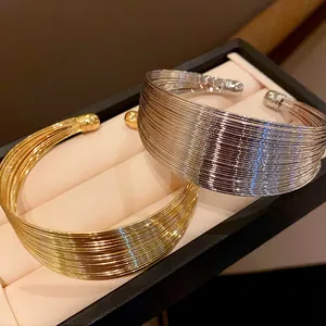Detailed view of elegant gold and silver multi-layer metal wire chokers in a box