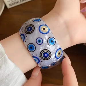 Statement iridescent acrylic wide open bangle with blue evil eye pattern for women