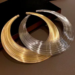 Close-up view of gold and silver multi-layer metallic torque choker necklaces for women