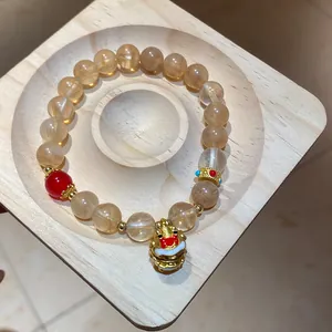 Elegante braccialetto in stile cinese con ciondolo a leone dorato e perla di agata rossa