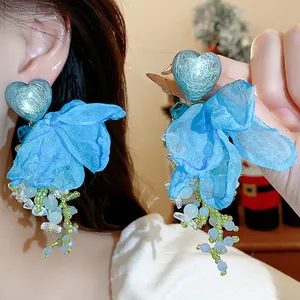 Detailed close-up of blue heart chiffon flower tassel earrings with intricate beadwork