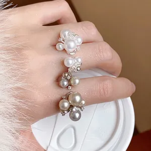 Elegant French style floral rings with faux pearls and zircon accents shown on hand