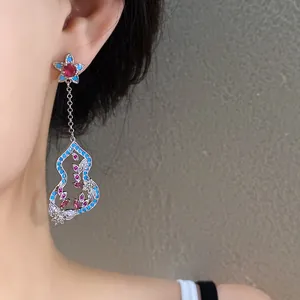 Close-up of New Chinese style hulu tassel earring with red and blue zircon flowers.