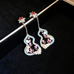 Exquisite macro detail of new Chinese style gourd drop earrings with colorful floral stones