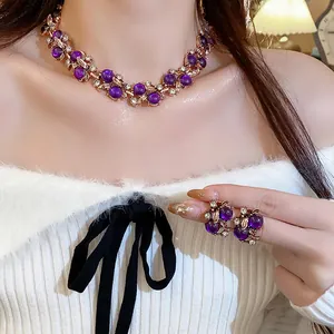 Detailed macro view of elegant floral leaf jewelry set with purple beads and crystals
