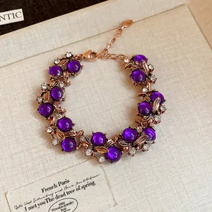 Elegant vintage court style bracelet featuring purple beads and crystal-encrusted leaves