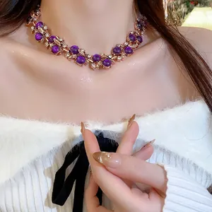 Close-up detail of vintage court style necklace with purple beads and floral leaf design.