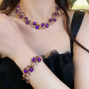 Detailed view of vintage jewelry set featuring purple beads and gold floral leaf accents
