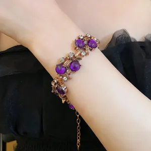 Detailed view of vintage court style bracelet with purple beads and rhinestones on wrist