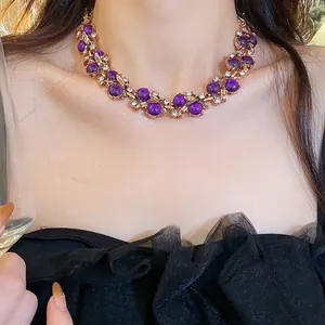 Close-up detail showing the vintage leaf design necklace with purple beads and diamonds