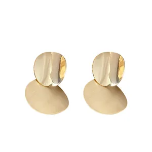 Elegant minimalist gold metallic stud earrings with brushed and polished round disks